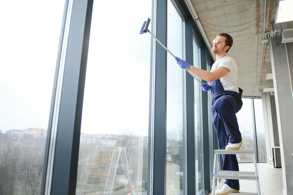 Desert Window Services technician cleaning windows on Las Vegas home - residential window cleaning